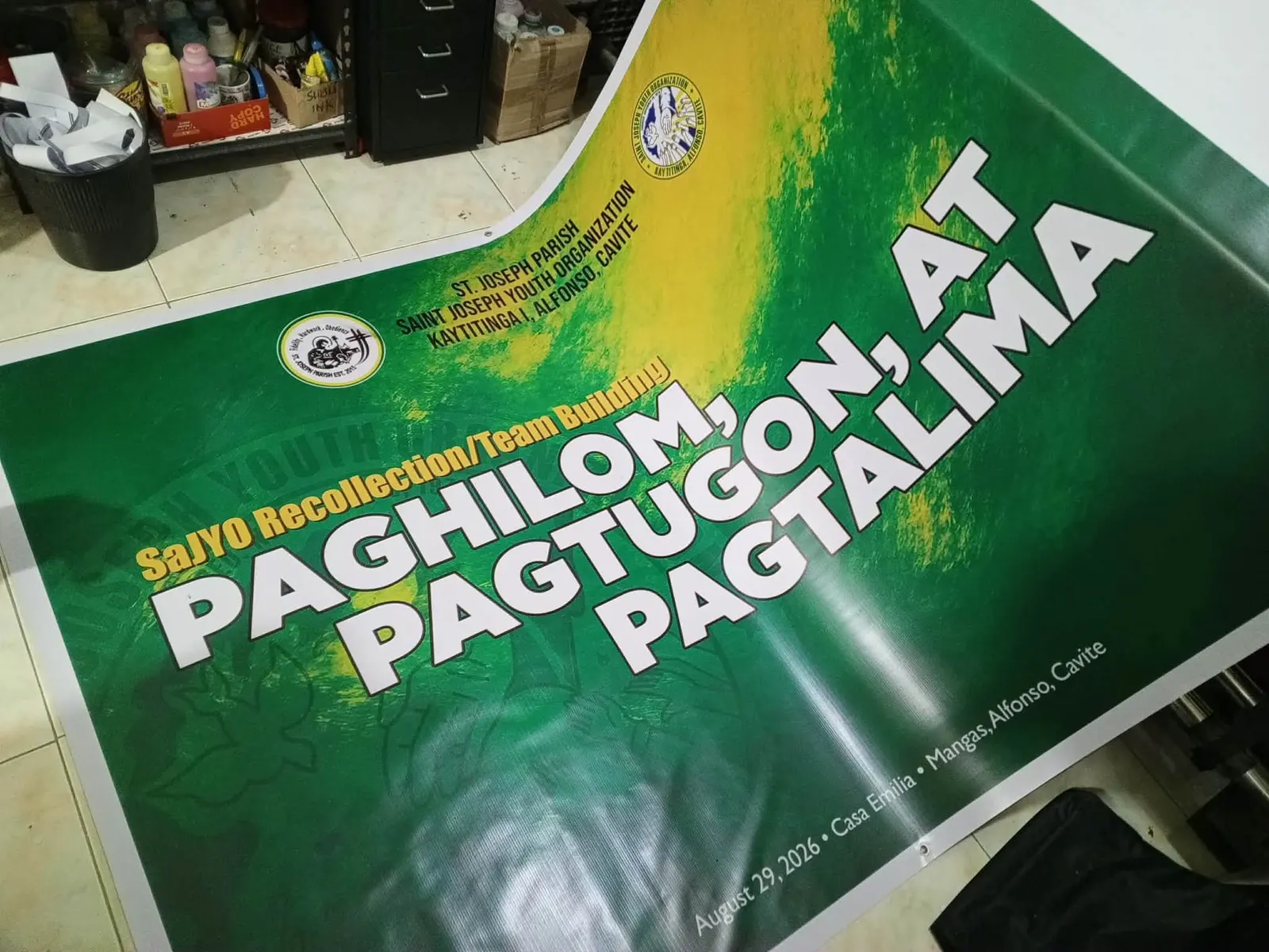 Green event tarpaulin for a parish youth recollection in Kaytitinga
